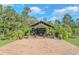 Relaxing outdoor pergola with seating area and lush landscaping at 2647 Zuni Rd, St Cloud, FL 34771