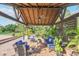 Covered patio with seating area, ceiling fan, and lush greenery at 2647 Zuni Rd, St Cloud, FL 34771