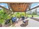 Covered patio with seating area, ceiling fan, and lush greenery at 2647 Zuni Rd, St Cloud, FL 34771