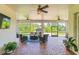 Relaxing screened patio with wicker furniture and brick pavers at 2647 Zuni Rd, St Cloud, FL 34771