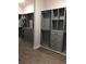 Spacious walk-in closet with gray custom shelving, drawers, and hardwood flooring at 2647 Zuni Rd, St Cloud, FL 34771