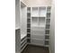 Spacious walk-in closet with white custom shelving and drawers at 2647 Zuni Rd, St Cloud, FL 34771