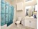 Bright bathroom features a shower, a single sink vanity, and a seashell-themed shower curtain at 2740 Maitland Crossing Way # 1, Orlando, FL 32810
