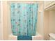 Bright bathroom features a tub/shower combo, seashell-themed shower curtain, and a matching teal towel at 2740 Maitland Crossing Way # 1, Orlando, FL 32810