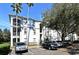 Three-story condo building featuring balconies, palm trees and ample parking at 2740 Maitland Crossing Way # 1, Orlando, FL 32810