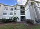 Condo building exterior showcasing multiple units, balconies, and landscaping at 2740 Maitland Crossing Way # 1, Orlando, FL 32810