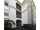 Three-story condo building with screened balconies and lush landscaping at 2740 Maitland Crossing Way # 1, Orlando, FL 32810
