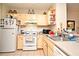 This kitchen is equipped with an electric range, plenty of cabinet space and a neutral color scheme at 2740 Maitland Crossing Way # 1, Orlando, FL 32810