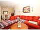 Bright living room featuring a red sectional sofa and artwork at 2740 Maitland Crossing Way # 1, Orlando, FL 32810