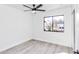 Bright bedroom featuring grey wood-look flooring and a ceiling fan at 37 Hickory Track Way, Ocala, FL 34472