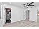 Bedroom with wood-look flooring, ensuite bathroom, and ceiling fan at 37 Hickory Track Way, Ocala, FL 34472