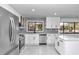 Modern kitchen with stainless steel appliances and white shaker cabinets at 37 Hickory Track Way, Ocala, FL 34472