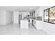 Modern kitchen with white cabinets, stainless steel appliances, and marble floors at 37 Hickory Track Way, Ocala, FL 34472