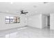 Open living room with marble floors and lots of natural light at 37 Hickory Track Way, Ocala, FL 34472