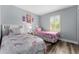 Twin bedroom with light gray walls and wood-look floors at 3715 Calabria Ave # 0, Davenport, FL 33897