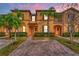 Attractive two-story townhome with brick pavers and lush landscaping at 3715 Calabria Ave # 0, Davenport, FL 33897