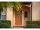 Well-maintained townhome entry with keypad and decorative window at 3715 Calabria Ave # 0, Davenport, FL 33897
