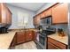 L-shaped kitchen with wooden cabinets and granite countertops at 3715 Calabria Ave # 0, Davenport, FL 33897