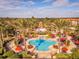 Expansive pool with surrounding lounge chairs and umbrellas in a tropical setting at 3715 Calabria Ave # 0, Davenport, FL 33897