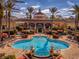 Resort-style pool with lounge chairs, umbrellas, and clubhouse in background at 3715 Calabria Ave # 0, Davenport, FL 33897
