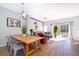 Bright dining area with wooden table and metal chairs, Mickey Mouse wall art, and view to the living room at 4706 Vero Beach Pl, Kissimmee, FL 34746