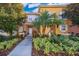 Inviting exterior of a two-story townhome with landscaping at 4706 Vero Beach Pl, Kissimmee, FL 34746