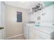 Laundry room with washer, dryer, and gold-speckled walls at 4706 Vero Beach Pl, Kissimmee, FL 34746