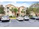 Condo building with parking lot and lush landscaping at 4881 Cypress Woods Dr # 3309, Orlando, FL 32811