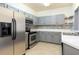 Modern kitchen with gray cabinets and stainless steel appliances at 4881 Cypress Woods Dr # 3309, Orlando, FL 32811