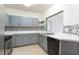 Modern kitchen with gray cabinets and stainless steel appliances at 4881 Cypress Woods Dr # 3309, Orlando, FL 32811