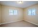 Well-lit bedroom with two windows and tile flooring at 5216 Montague Pl, Orlando, FL 32808