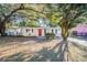 Updated one-story home with red front door and mature landscaping at 5216 Montague Pl, Orlando, FL 32808
