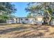 Ranch style house with a backyard and mature trees at 5216 Montague Pl, Orlando, FL 32808