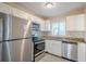 Renovated kitchen, white cabinets, granite counters, stainless steel appliances at 5216 Montague Pl, Orlando, FL 32808