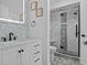 Updated bathroom with white vanity and gray tile at 604 Northlake Dr, Sanford, FL 32773