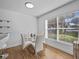 Bright dining area with a glass table and four chairs near a window at 604 Northlake Dr, Sanford, FL 32773