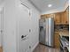 Kitchen features stainless steel refrigerator and wood cabinets at 604 Northlake Dr, Sanford, FL 32773