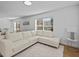 Living room with hardwood floors, white couch, and large window at 604 Northlake Dr, Sanford, FL 32773
