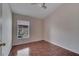 Simple bedroom with wood-look floors and window at 6433 Livewood Oaks Dr, Orlando, FL 32818