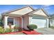 Tan house with white garage door and red walkway at 6433 Livewood Oaks Dr, Orlando, FL 32818