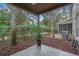 Private backyard patio with wood chips and lush landscaping at 8426 Chamberlain Pl, Oviedo, FL 32765