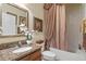 Bathroom featuring a tub, granite vanity, and decorative curtain at 8426 Chamberlain Pl, Oviedo, FL 32765