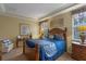 Bedroom with wooden bed frame, nightstands, and neutral decor at 8426 Chamberlain Pl, Oviedo, FL 32765