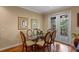 Dining area with glass table, four chairs, and access to a patio at 8426 Chamberlain Pl, Oviedo, FL 32765