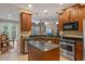 Kitchen with an island, stainless steel appliances, and hardwood floor at 8426 Chamberlain Pl, Oviedo, FL 32765