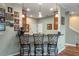 Breakfast bar with three wrought-iron stools at 8426 Chamberlain Pl, Oviedo, FL 32765