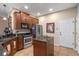 Kitchen with island, stainless steel appliances, and wood cabinets at 8426 Chamberlain Pl, Oviedo, FL 32765