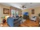 Living room with hardwood floors, neutral walls, and a large TV at 8426 Chamberlain Pl, Oviedo, FL 32765