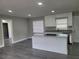 Modern kitchen with white cabinets, granite countertops, and an island at 2113 Winnetka Ct, Orlando, FL 32818