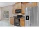Kitchen boasts stainless steel appliances and wood cabinets at 10952 Arbor View Blvd, Orlando, FL 32825